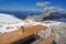 Beauty of nature, amazing alpine landscape with rocks, peaks overcovered with snow, tourists walking in mount, blue sky, sun, snow