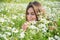 beauty of nature. woman in camomile field. summer flower meadow. beautiful lady among chamomile.
