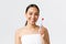 Beauty, personal care, and hygiene concept. Close-up of beautiful healthy asian girl in bath towel, showing toothbrush