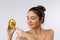 Beauty, personal care, spa and skincare concept. Close-up of beautiful woman in bath towel gently touching an avocado as