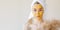 Beauty photo of a woman with homemade mask on her face. Blurred dried wildflowers. Wide banner with copy space