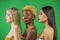 Beauty portrait of asian, african and european girls with bare shoulders and fashionable make on green background. Three