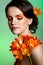 Beauty portrait of a beautiful girl with flower clivia