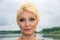Beauty portrait of caucasian white girl with short blondie hair in outdoor. Smokey eyes makeup.