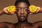 Beauty portrait of half-naked african woman holding kiwano horned melon