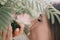 Beauty portrait of happy woman closeup. Young girl smelling Chinese acacia pink blossoming flowers. Portrait of young