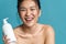 Beauty portrait of a smiling topless young asian woman