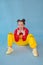 beauty portrait of stylish teenage girl in fashionable bright clothes. tween wearing red and yellow clothes on blue