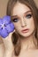 Beauty portrait of a woman with a blue Vanda Orchid in her hand. Natural cosmetics made of flower petals, clean delicate skin of