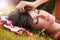 Beauty portrait of woman with flower petals near face