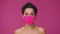 Beauty portrait of young African American woman in pink protective pitta mask looking at camera. Black female nude model