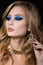 Beauty portrait of young blonde woman with blue smokey eyes make