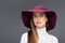 beauty posing in burgundy felt hat