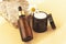 Beauty products: cream jar, serum on natural stone, yellow background, top view. Natural cosmetics and skin care concept