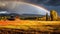 Beauty rainbow in storm cloud above autumn field landscape. Weather, nature background.