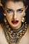 beauty rich brunette woman with a lot of gold jewellery, hispani