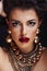 beauty rich brunette woman with a lot of jewellery, hispanic curly lady posing very emotional