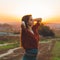 Beauty Romantic Girl Outdoors enjoying nature. Beautiful autumn model in nature in the rays of sunset. Sun light on sunset.