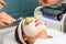 Beauty salon face treatment with cucumber mask