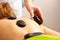 Beauty salon. Woman getting spa hot stone therapy massage