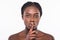 Beauty, skincare. Beautiful african woman silence gesture on a white background