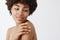 Beauty, skincare and people concept. Close-up shot of tender feminine african american woman with curly hair, turning