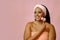 beauty smiling black woman with perfect skin in towel and facial cleansing brush looking away at copy space