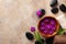 Beauty, spa background with massage stone and flowers on brown background top view. Relaxation and wellness concept. Flat lay