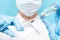 Beauty spa doctor holding syringe on blue background. Concept lip enlargement injection, anti-aging serum, plastic