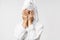 Beauty, spa and leisure concept. Funny asian man in bathrobe and bath towel over head, coming from shower, hiding face