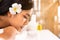 Beauty, spa, resort and relaxation concept - beautiful woman in spa salon