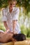 Beauty Spa Treatment-Smiling masseur is massaging a female in na