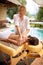 Beauty Spa Treatment-Smiling masseur is massaging a woman at home.