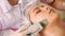 Beauty Specialist Makes Ultrasonic Peeling For Female Client\'s Face. Cosmetologist doing procedure of cleaning face with