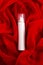 Beauty spray (aerosol) over red cloth background