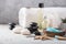 Beauty still life of massage oil bottle of aroma essential   and natural fragrance salt with stones, candles on concrete grey