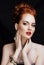 Beauty stylish redhead woman with hairstyle and manicure wearing