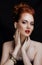 Beauty stylish redhead woman with hairstyle and manicure wearing jewelry pearl close up