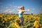 Beauty sunlit woman on yellow sunflower field Freedom and happiness concept. Happy girl outdoors