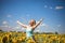 Beauty sunlit woman on yellow sunflower field Freedom and happiness concept. Happy girl outdoors