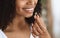 Beauty Supplement. Closeup Of Smiling Black Woman Taking Vitamin Pill Capsule