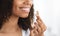 Beauty Supplement. Smiling Black Girl Taking Biotin Vitamin Capsule For Healthy Skin