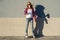 A beauty teen model girl, shod in rollerblades holding a water b