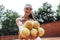 Beauty on tennis court. Cropped image of blurred sporty attractive girl with focus on tennis balls in her hands. Sexy young woman