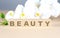 Beauty Text On Wooden Blocks with white orchid