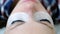 Beauty treatment. Closeup eyes in woman`s face with paint on eyelashes. laminating eyelashes.