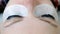 Beauty treatment. Closeup eyes in woman`s face with paint on eyelashes. laminating eyelashes.