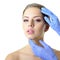 Beauty treatment of the young beautiful female face, doctor`s ha