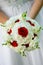 Beauty wedding bouquet of red roses and white flowers