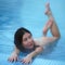 Beauty woman bathing in pool with thermal water in balneotherapy spa, hot springs resorts